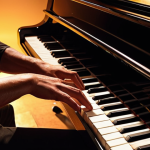 **

A close-up shot of a musician passionately playing a piano, bathed in warm, focused stage lighting. The scene should evoke a sense of dedication, skill, and emotional connection to the music. Focus on details like the musician's hands on the keys, the polished surface of the piano, and the expressive face of the musician.

**